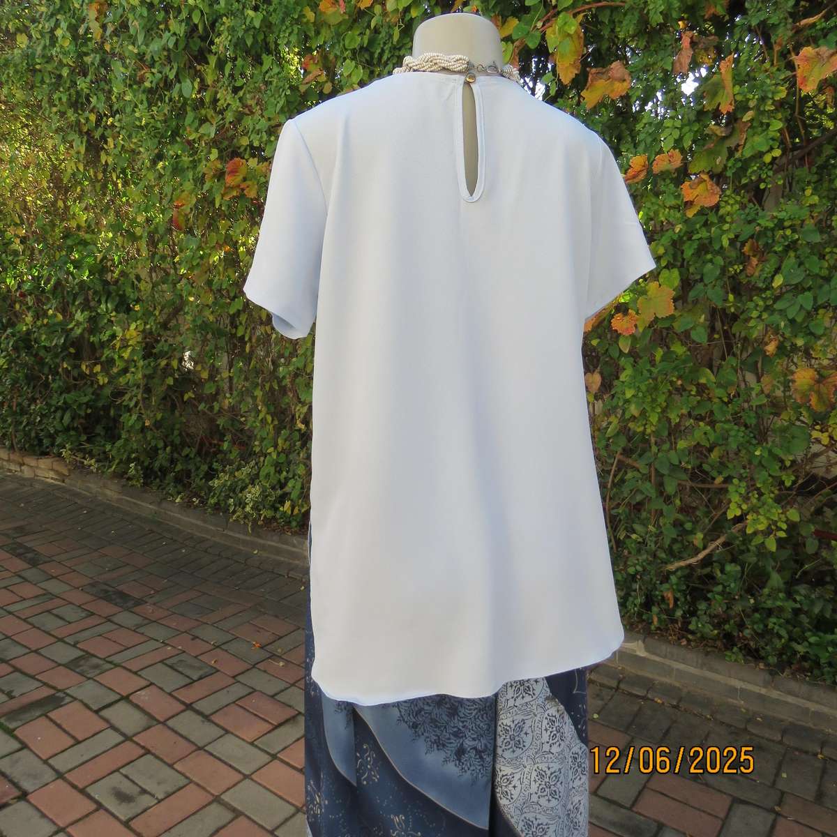 Light blue textured polyester slip over short sleeve top. Size 34. As new