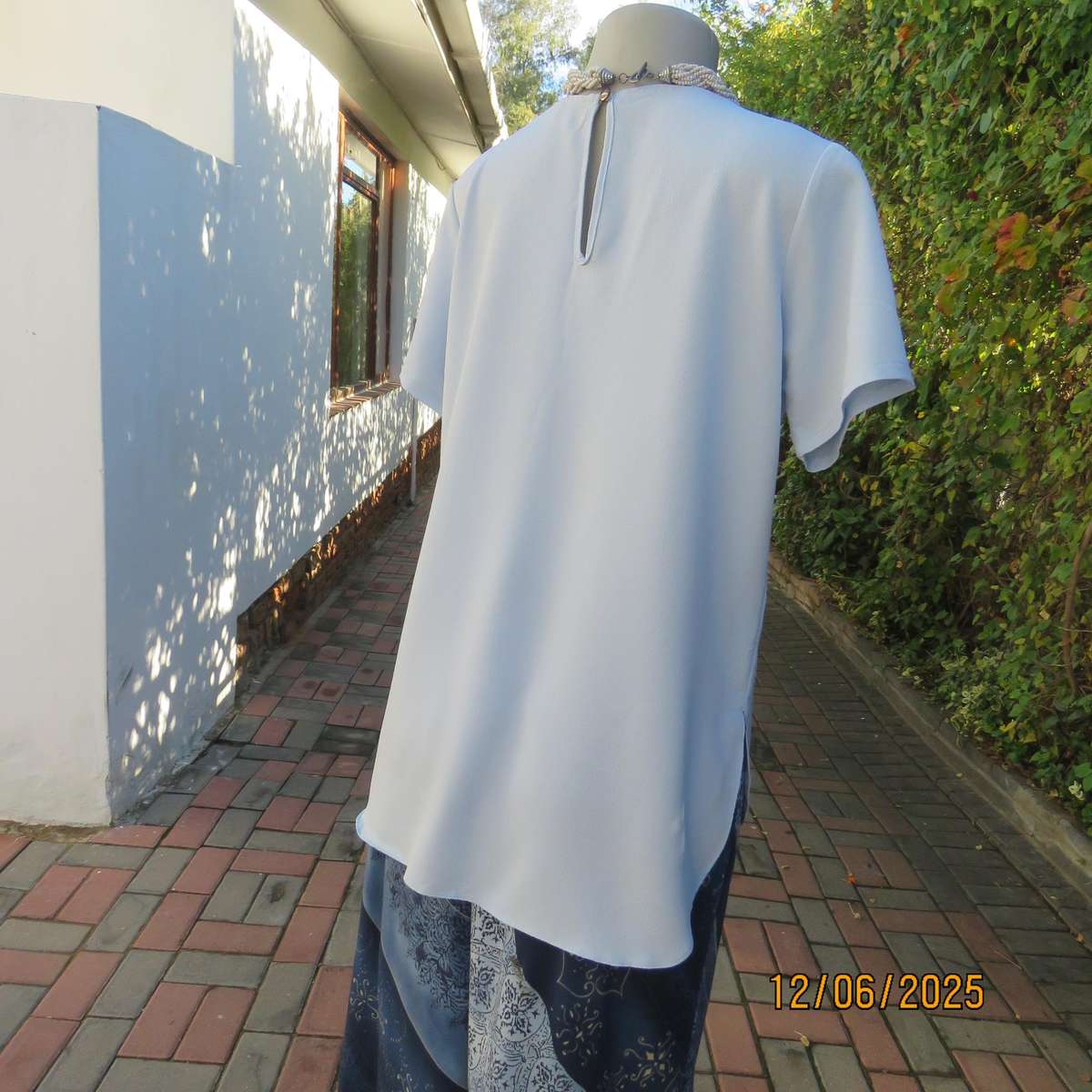 Light blue textured polyester slip over short sleeve top. Size 34. As new