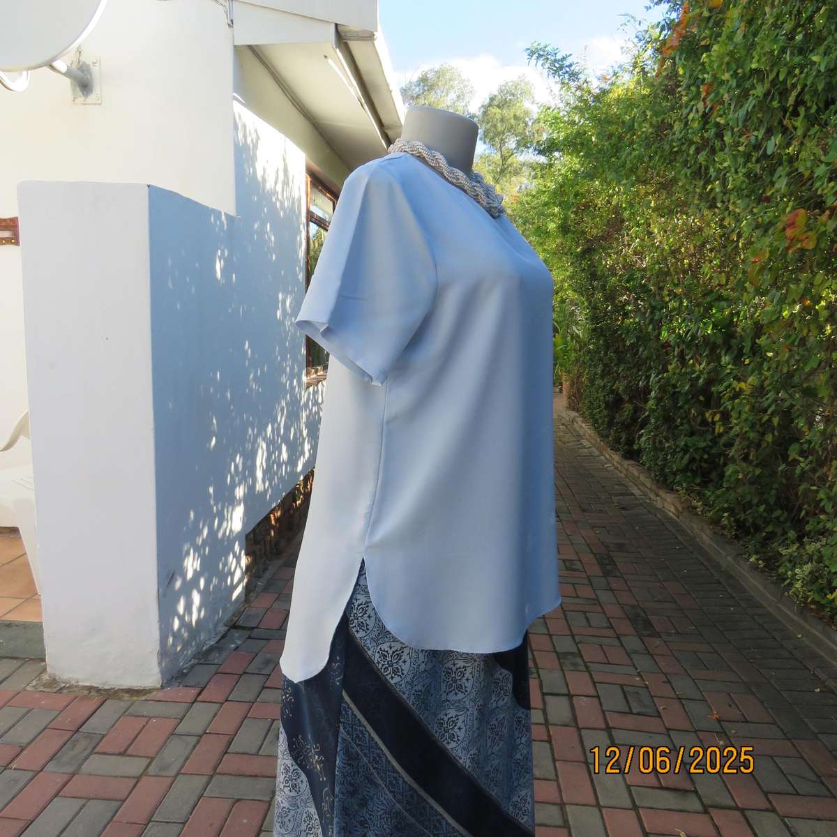 Light blue textured polyester slip over short sleeve top. Size 34. As new