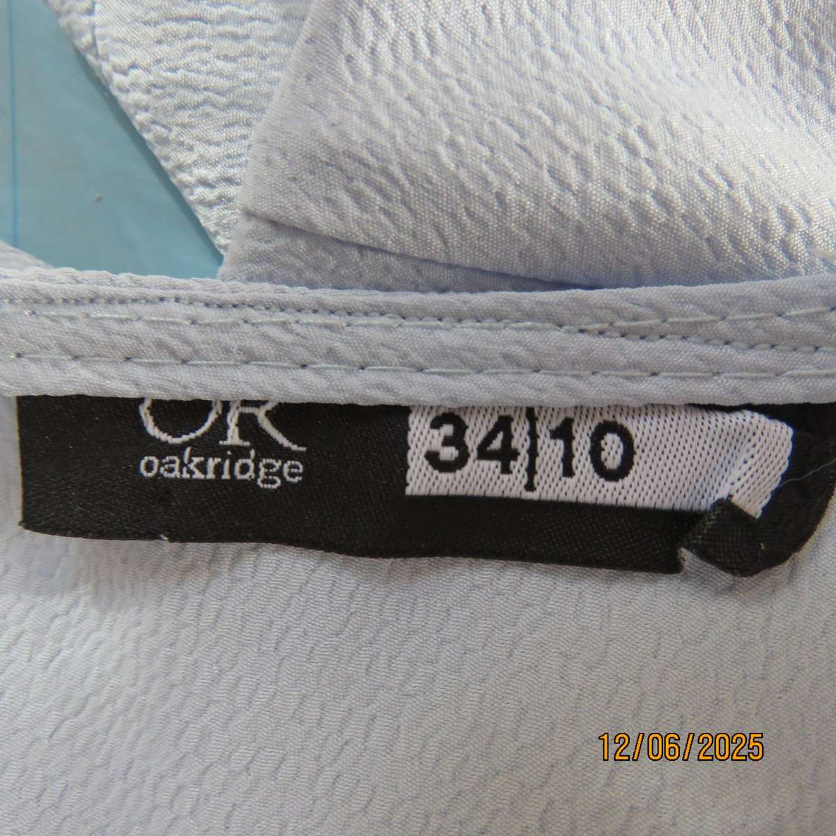 Light blue textured polyester slip over short sleeve top. Size 34. As new