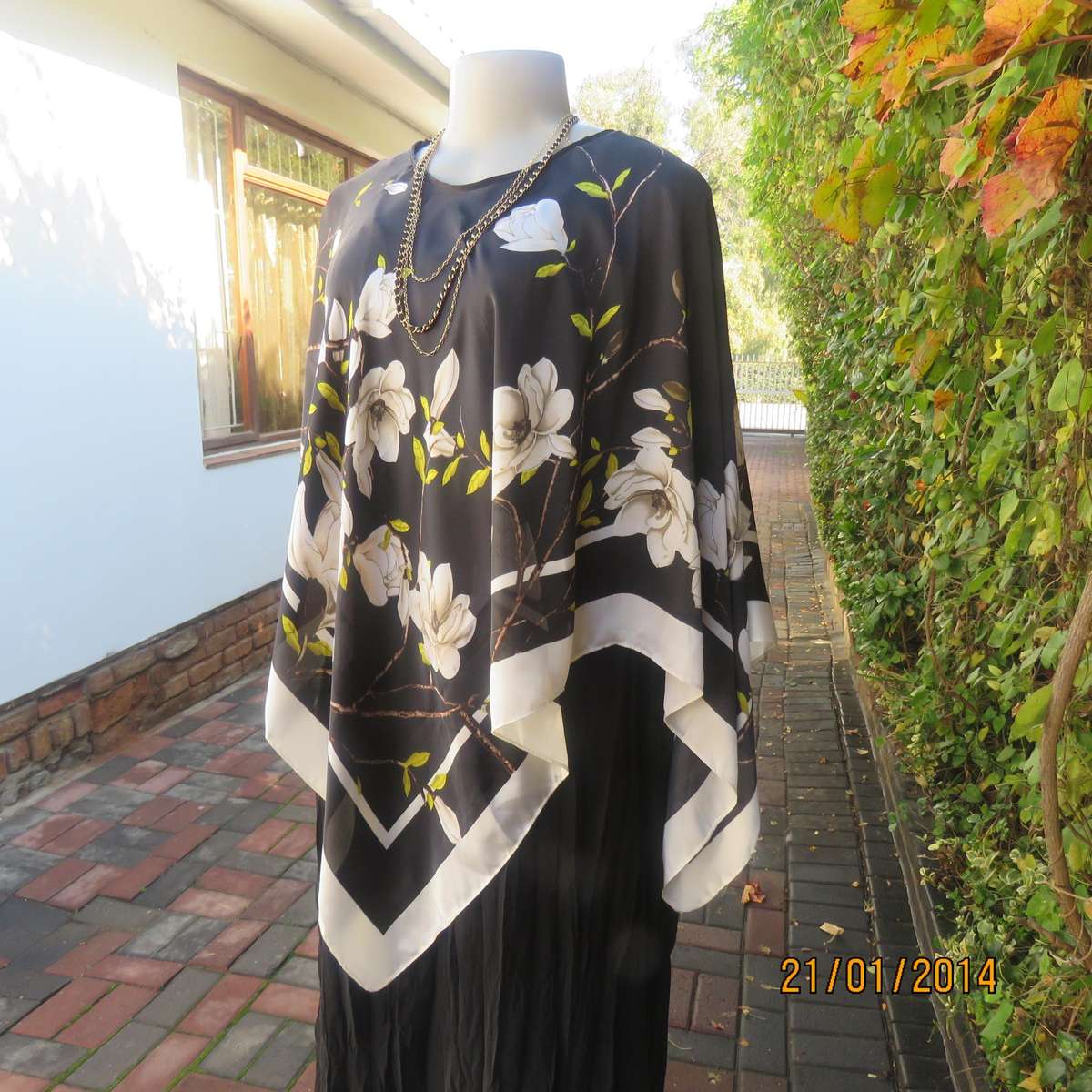 Soft silky black throw over with cream edges and cream flowers, round neck.