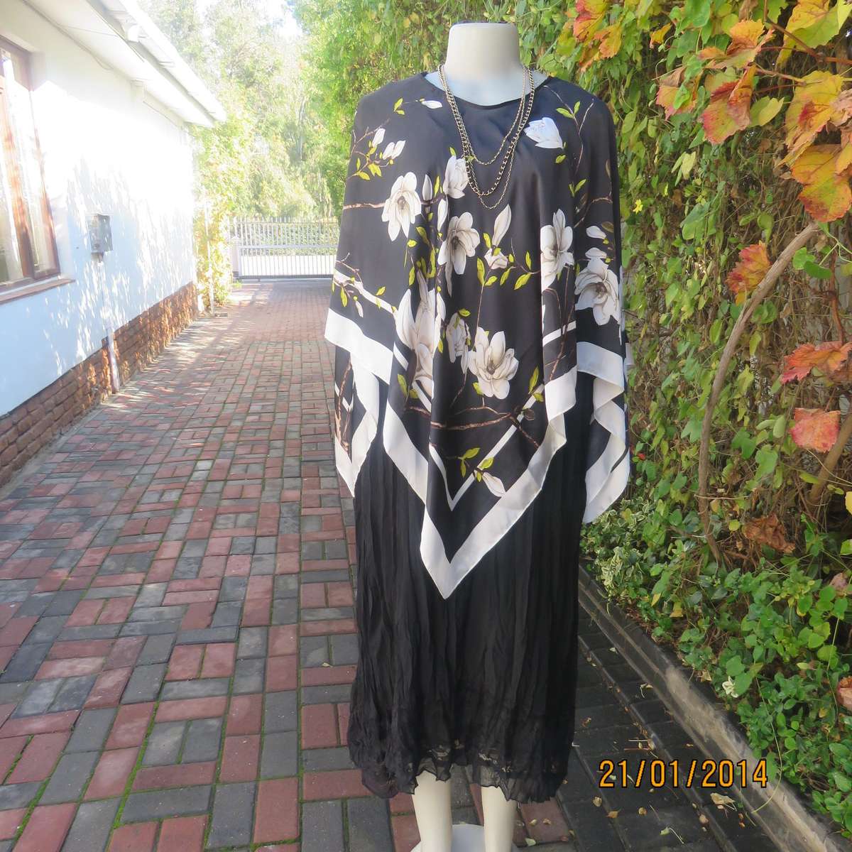 Soft silky black throw over with cream edges and cream flowers, round neck.