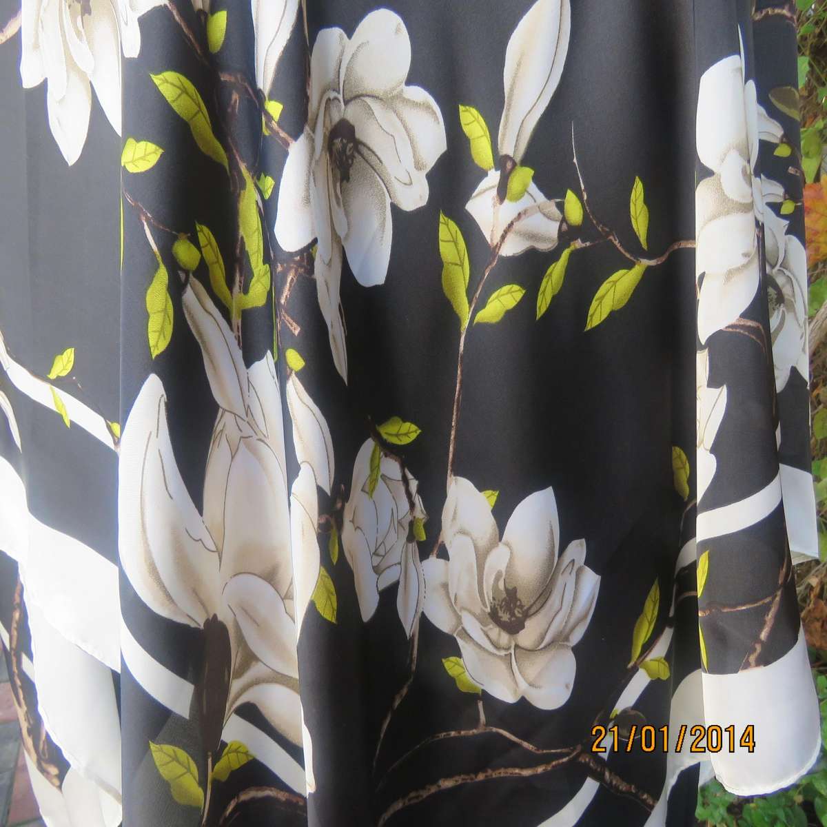 Soft silky black throw over with cream edges and cream flowers, round neck.