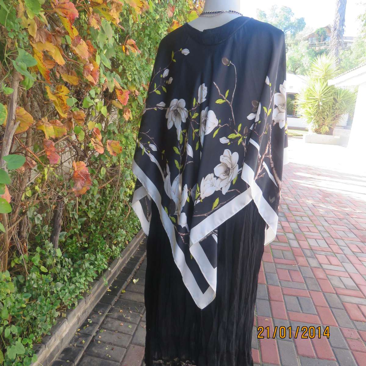 Soft silky black throw over with cream edges and cream flowers, round neck.