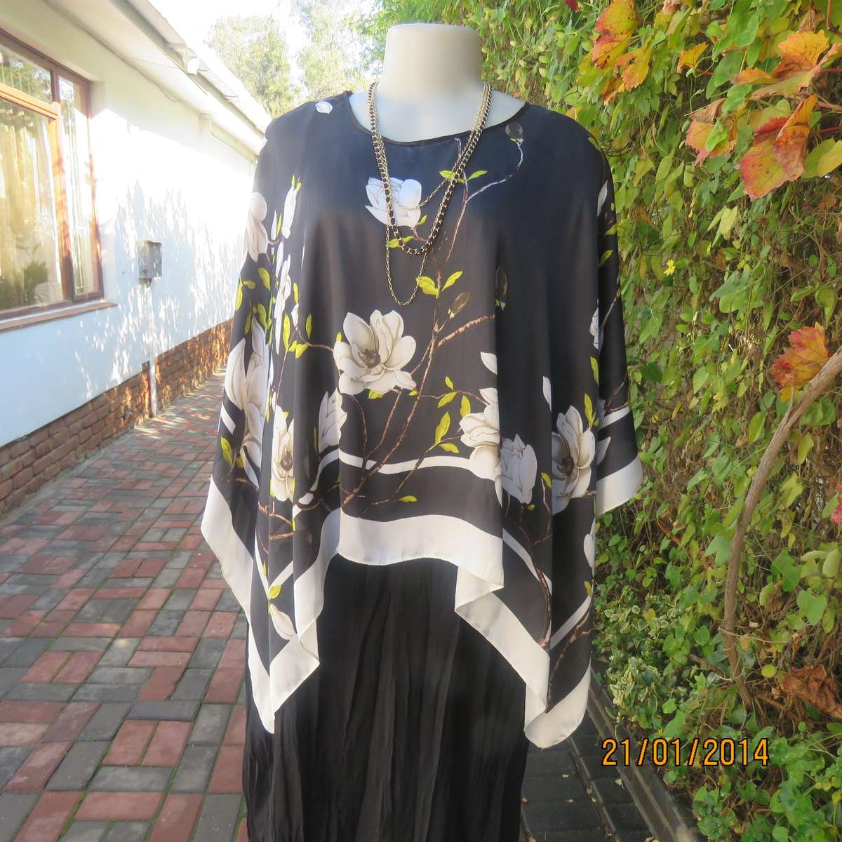 Soft silky black throw over with cream edges and cream flowers, round neck.
