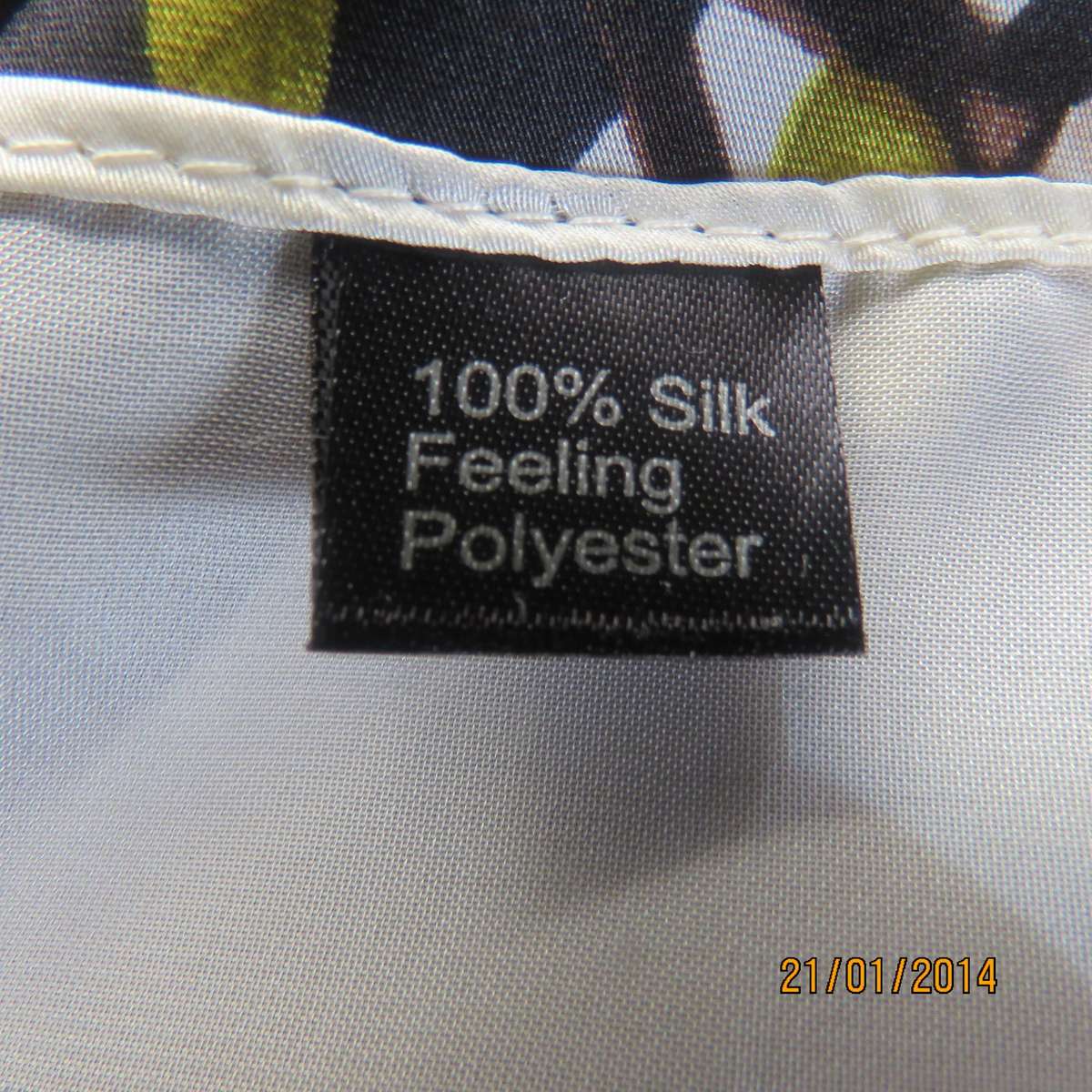 Soft silky black throw over with cream edges and cream flowers, round neck.