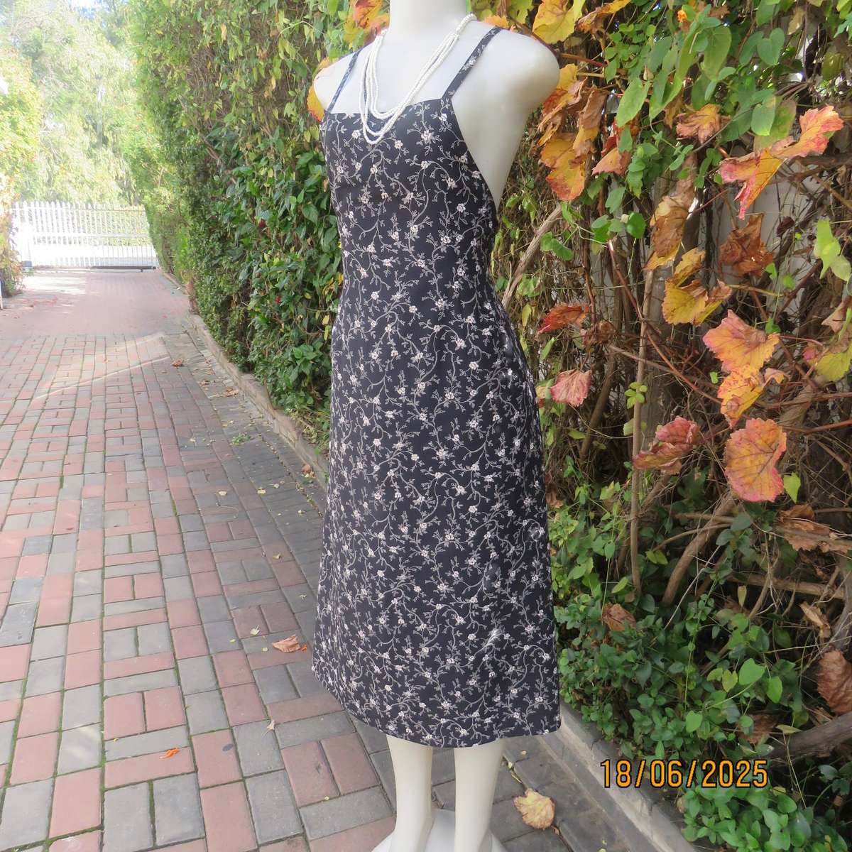 MADY black-white floral polyester low calf length dress. Bib front with straps. Size 34.