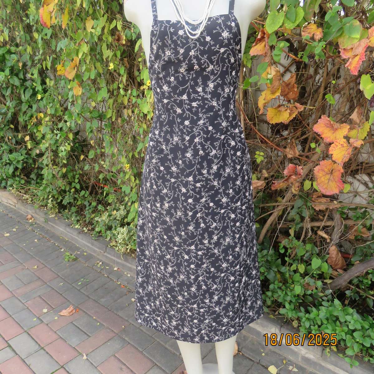 MADY black-white floral polyester low calf length dress. Bib front with straps. Size 34.