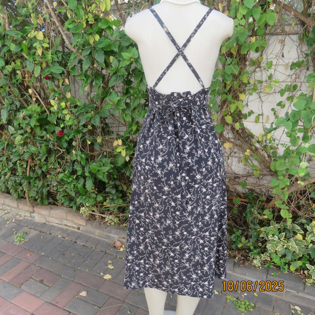MADY black-white floral polyester low calf length dress. Bib front with straps. Size 34.