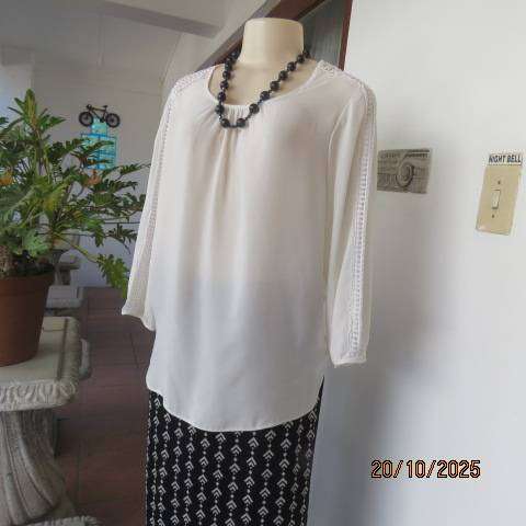 OASIS white free falling slip over top. Lace from neck to sleeve cuffs. Size 36
