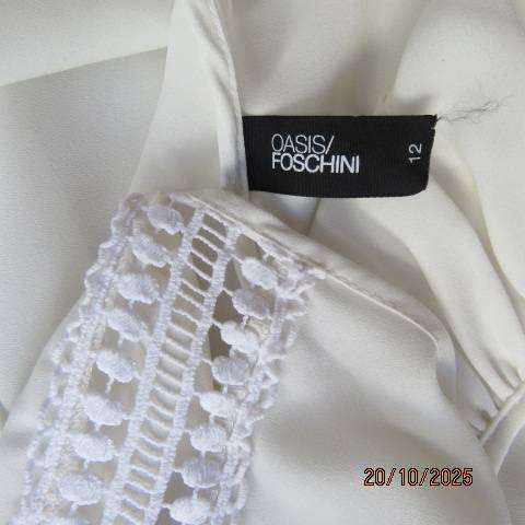 OASIS white free falling slip over top. Lace from neck to sleeve cuffs. Size 36