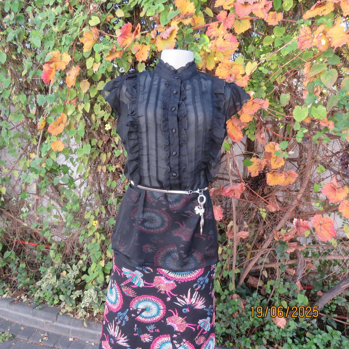 NOSTALGIA sheer black polyester peplum size 37 top. Halfway button down.