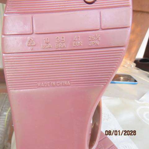 Pair of brownish pink flat sandals in bendable plastic with pretty bow. Size 8
