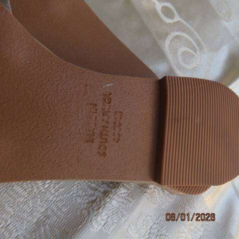 Pair of flip flop sandals with clear band with silver over foot. Never worn. Size 8