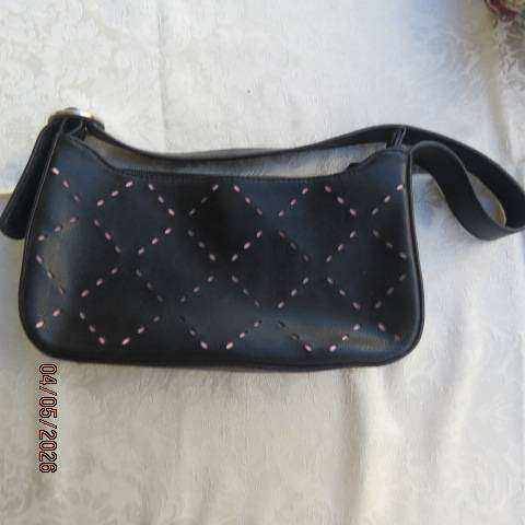 Black synthetic small handbag with diamond pattern holes and pale pink underlayer