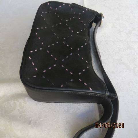 Black synthetic small handbag with diamond pattern holes and pale pink underlayer