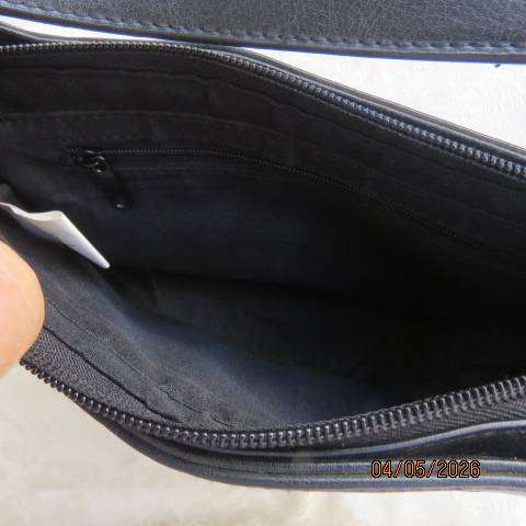Black synthetic small handbag with diamond pattern holes and pale pink underlayer