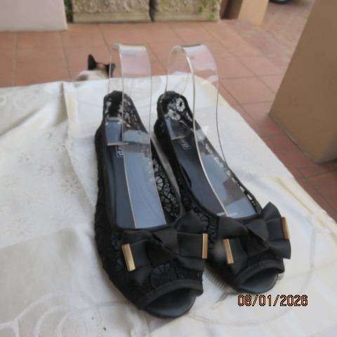 Pair of black floral pattern gauze flat shoes with open toes and bows on front. Size 8