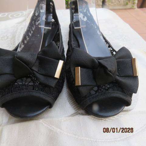 Pair of black floral pattern gauze flat shoes with open toes and bows on front. Size 8