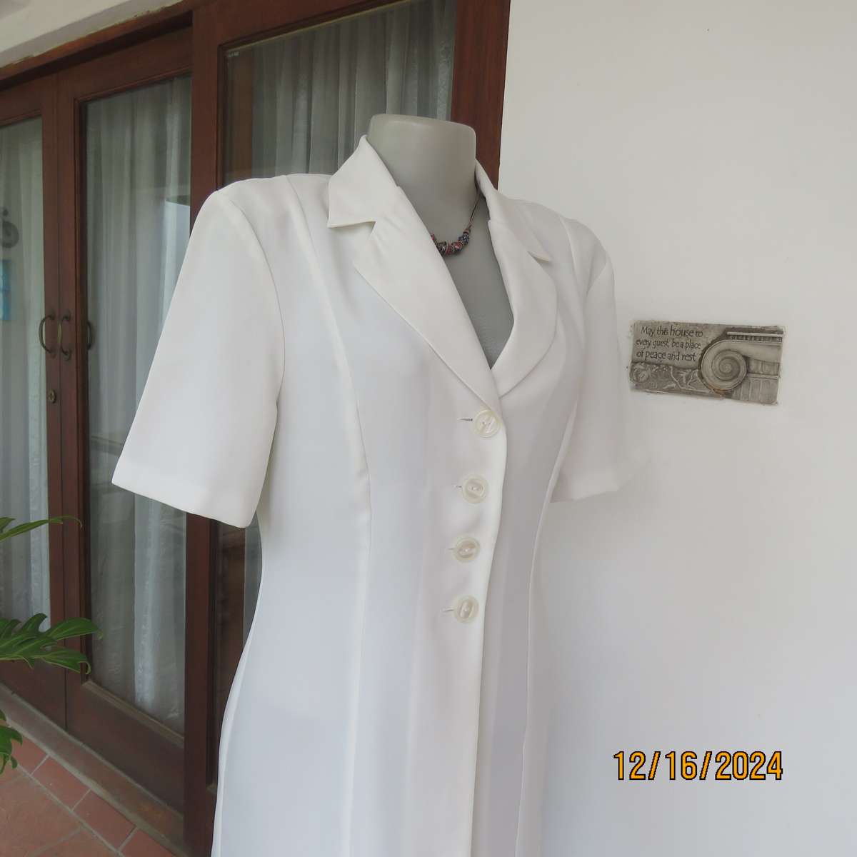 Elegant light cream tailored jacket closing with 4 front buttons. Collar and short sleeves.Size 34