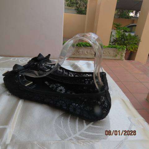 Pair of black floral pattern gauze flat shoes with open toes and bows on front. Size 8