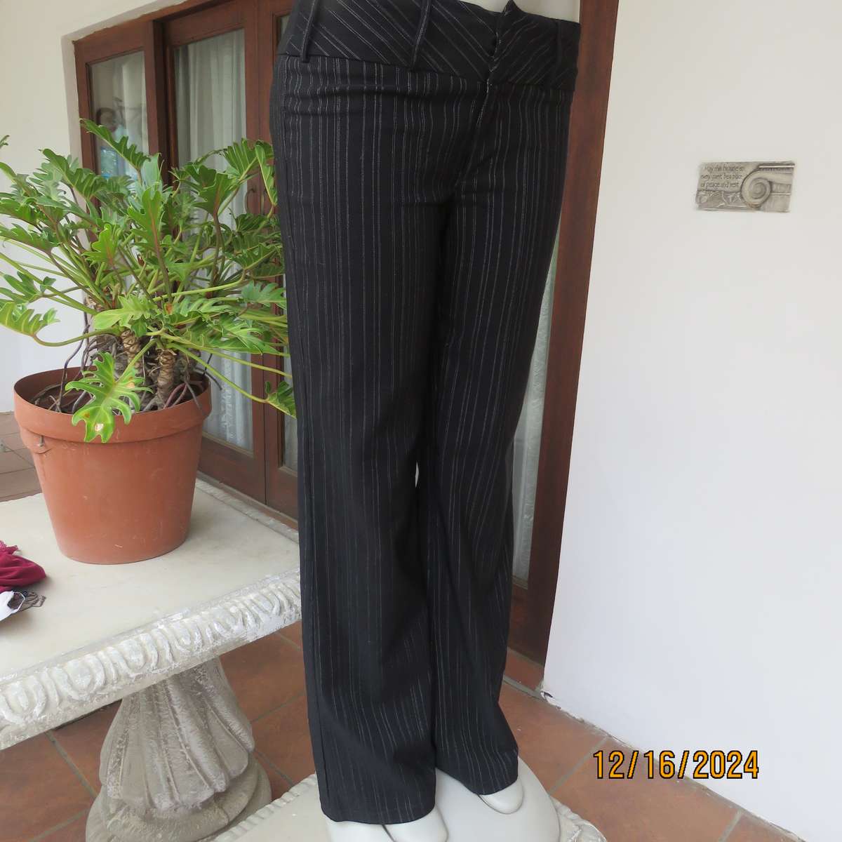 Black pinstripe bootlegged polyester-rayon stretch pants size 34. Dummy pockets at back. As new con.