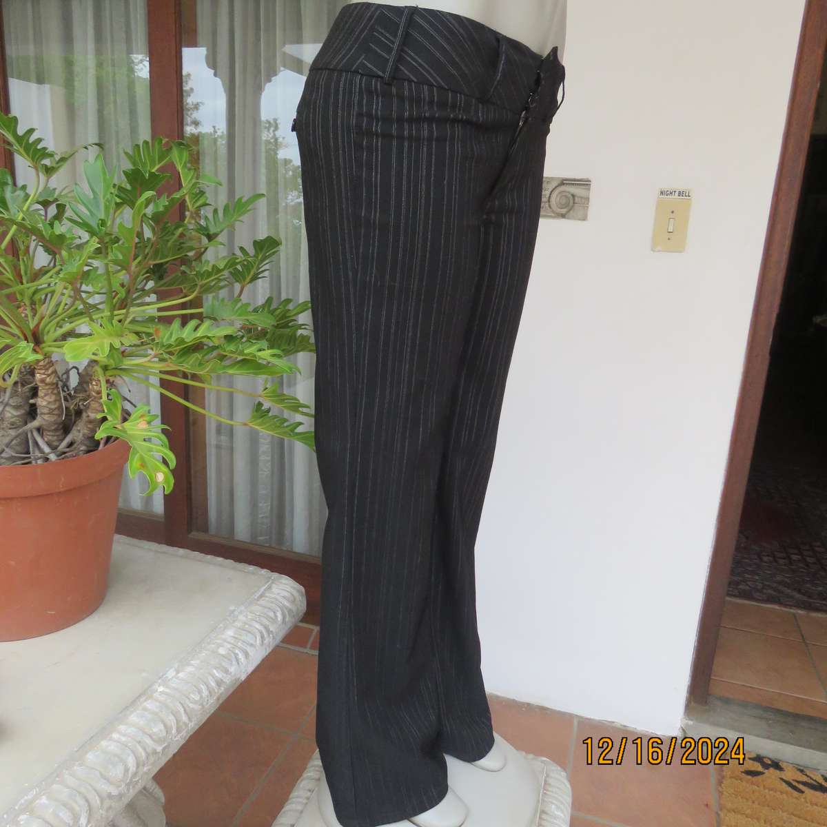 Black pinstripe bootlegged polyester-rayon stretch pants size 34. Dummy pockets at back. As new con.