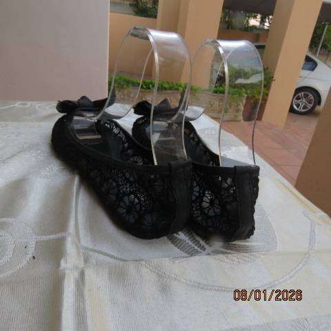 Pair of black floral pattern gauze flat shoes with open toes and bows on front. Size 8