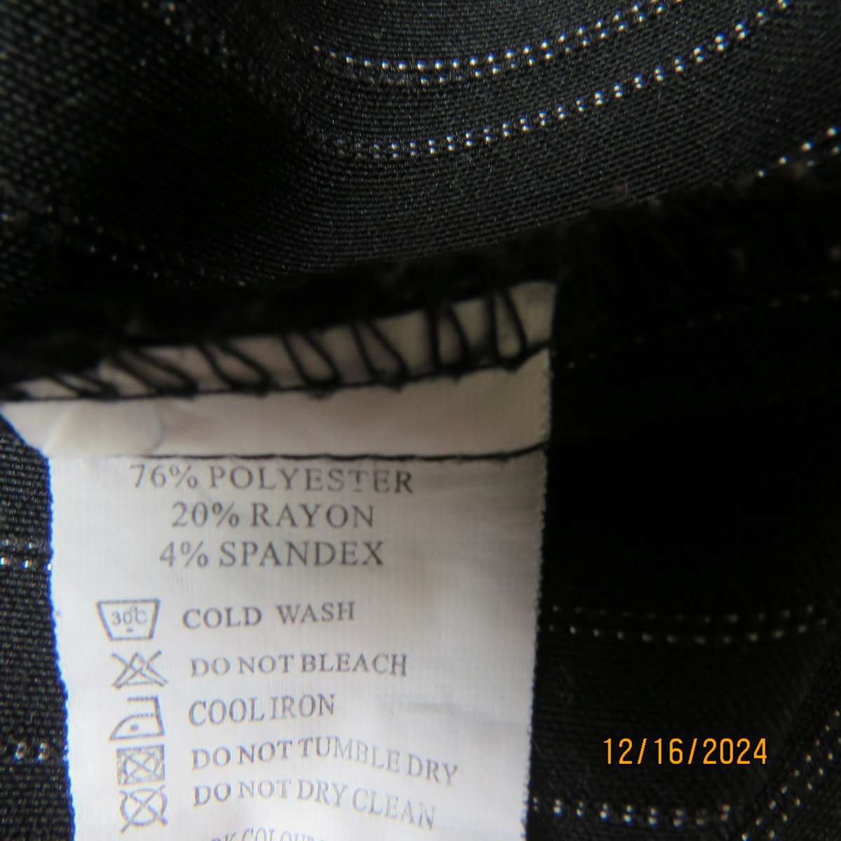 Black pinstripe bootlegged polyester-rayon stretch pants size 34. Dummy pockets at back. As new con.