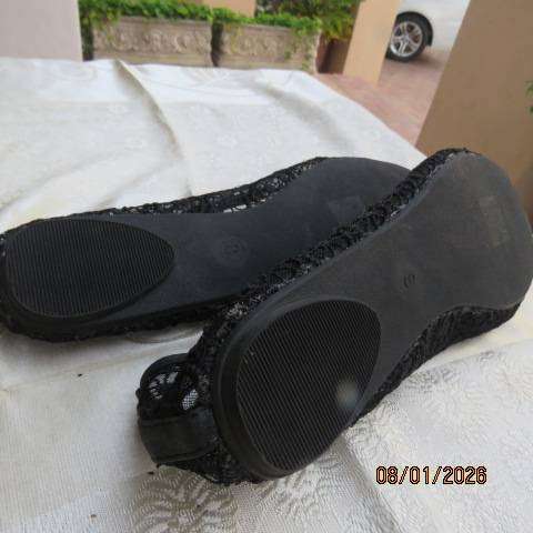 Pair of black floral pattern gauze flat shoes with open toes and bows on front. Size 8