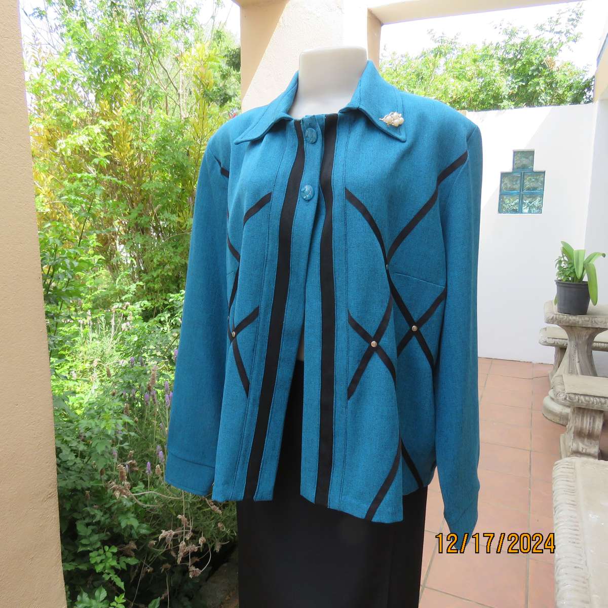 State of the art blue jade -black mottled polyester jacket.Criss-cross black decoration.Size 42.
