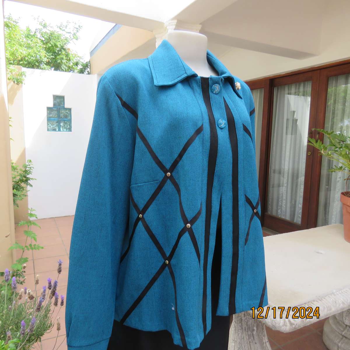 State of the art blue jade -black mottled polyester jacket.Criss-cross black decoration.Size 42.