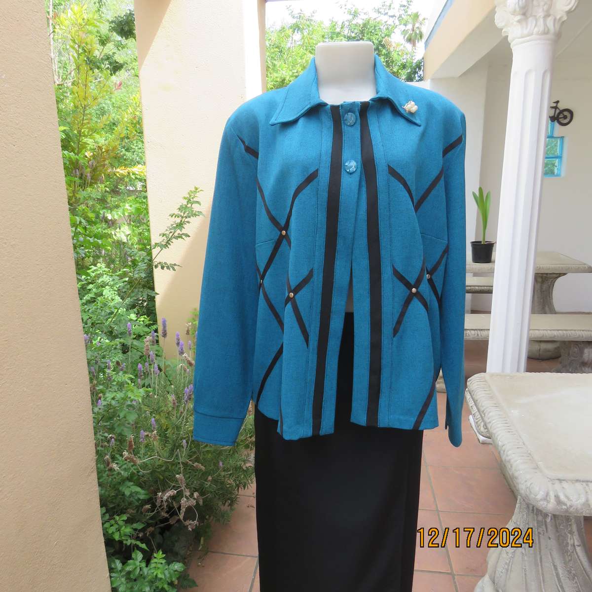 State of the art blue jade -black mottled polyester jacket.Criss-cross black decoration.Size 42.