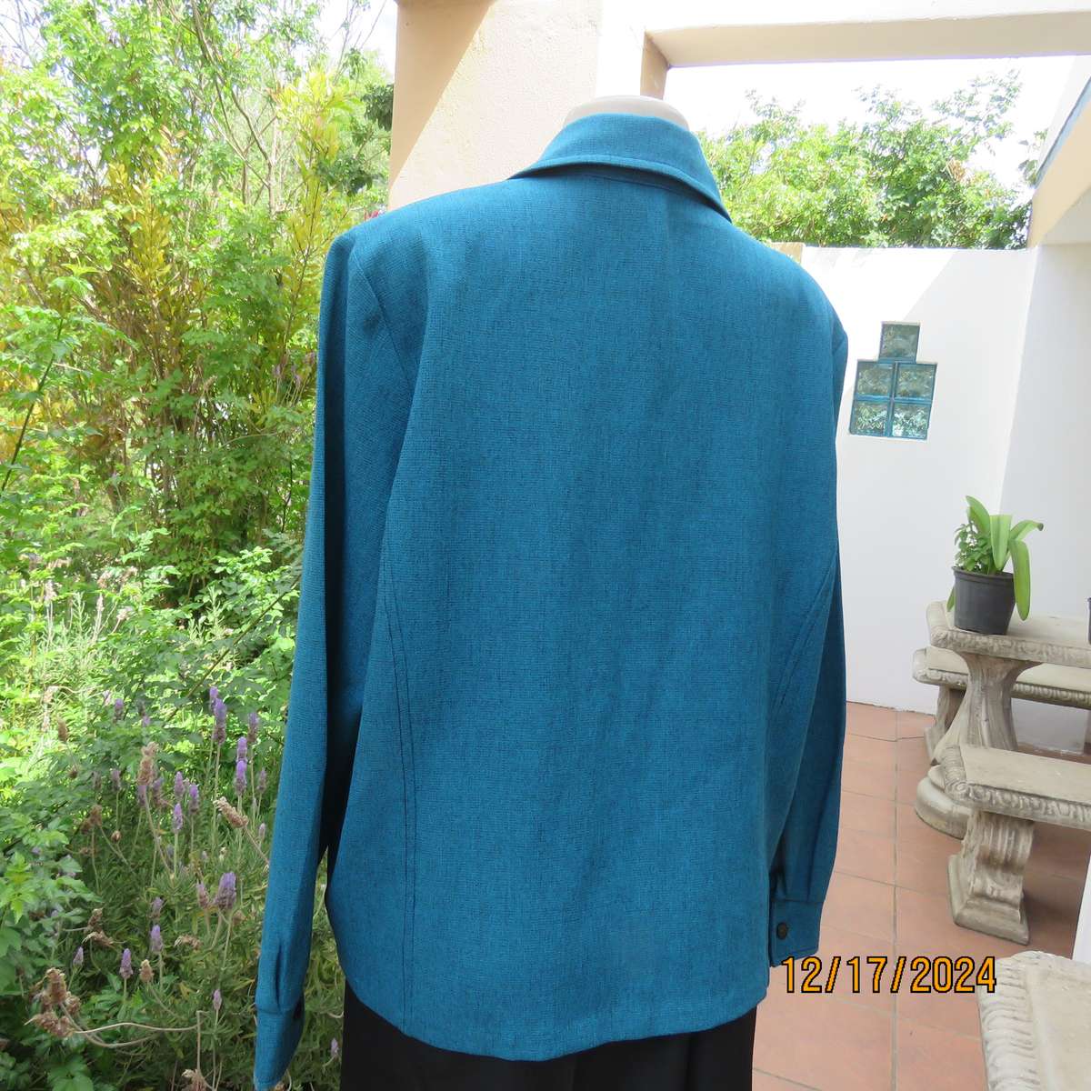 State of the art blue jade -black mottled polyester jacket.Criss-cross black decoration.Size 42.
