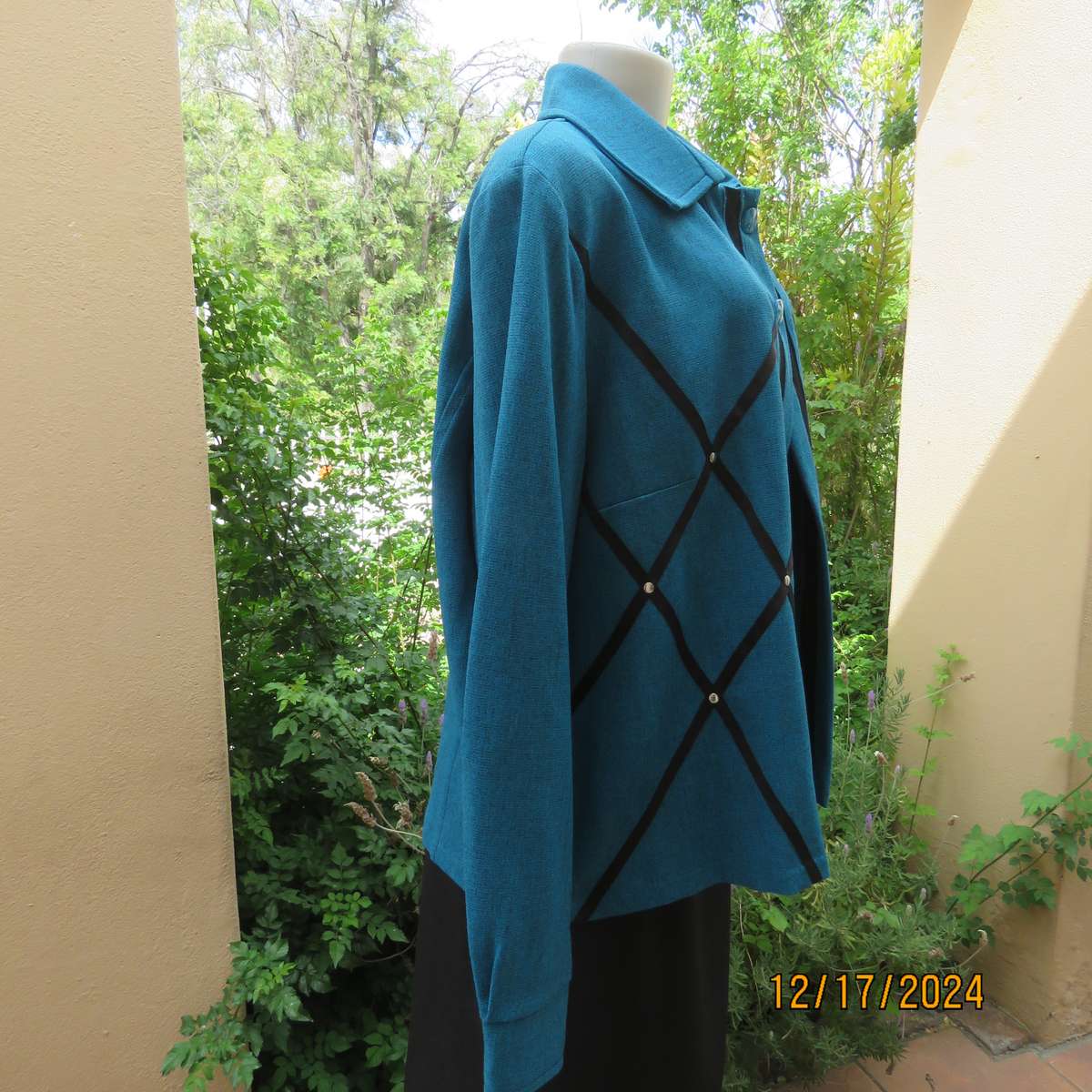 State of the art blue jade -black mottled polyester jacket.Criss-cross black decoration.Size 42.