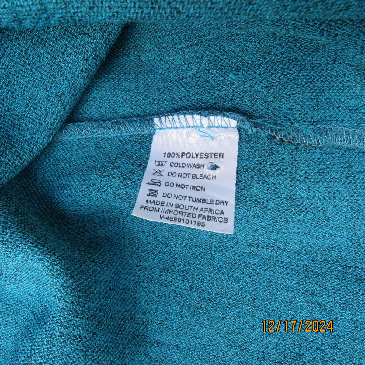 State of the art blue jade -black mottled polyester jacket.Criss-cross black decoration.Size 42.