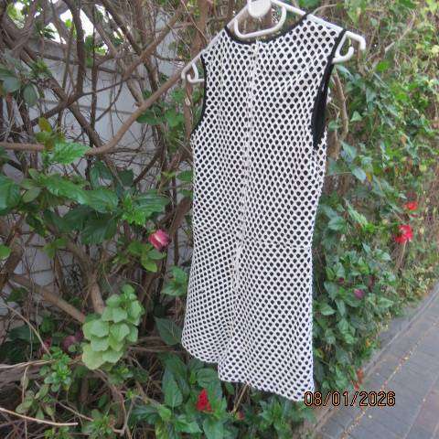 Girls black stretch polyester short jumpsuit with cream mesh overlay. For 13-14 yr old.