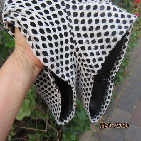 Girls black stretch polyester short jumpsuit with cream mesh overlay. For 13-14 yr old.