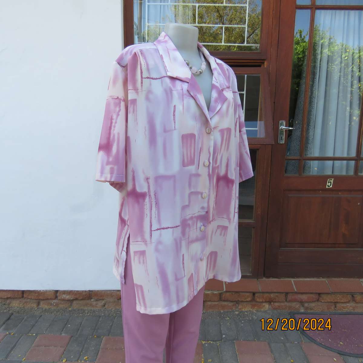 Boutique made button down short sleeve open collar top. Pleated yokes.Size 50 Pink print.
