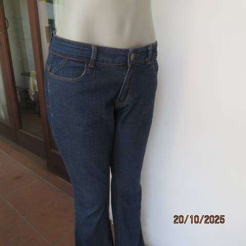 Blue denim jeans in stretch polycotton with flare legs. Size 36