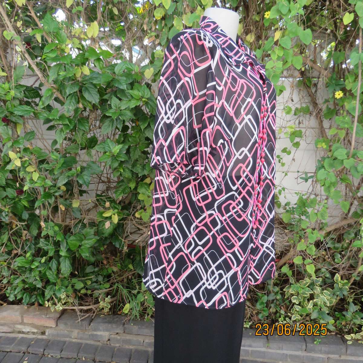ANNA PIA black sheer polyester sheer polyester top with pink-white link print. Size large 44