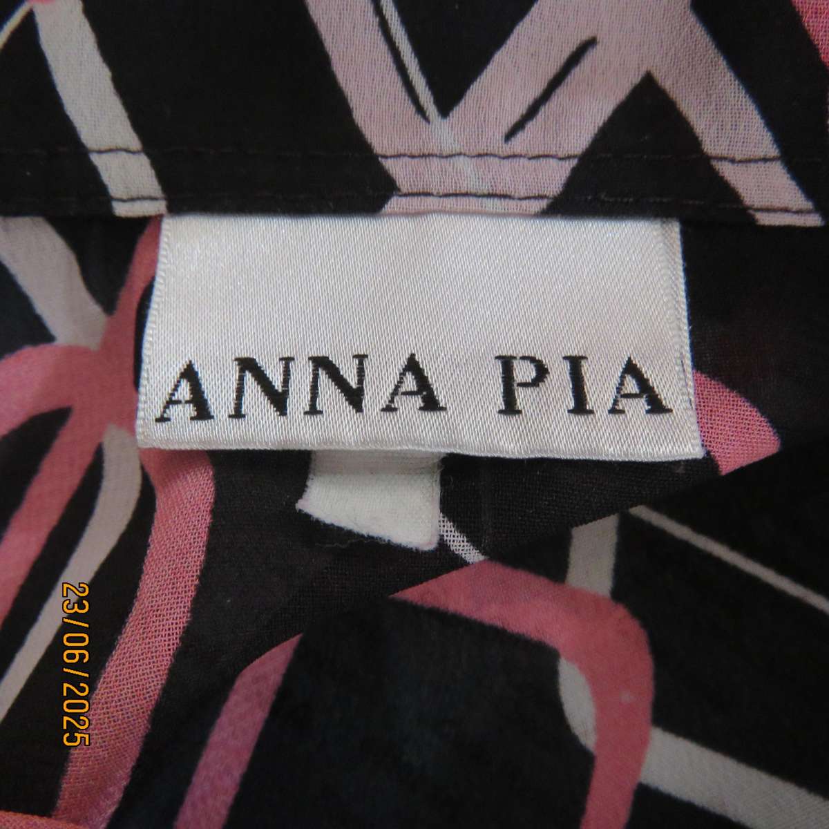 ANNA PIA black sheer polyester sheer polyester top with pink-white link print. Size large 44