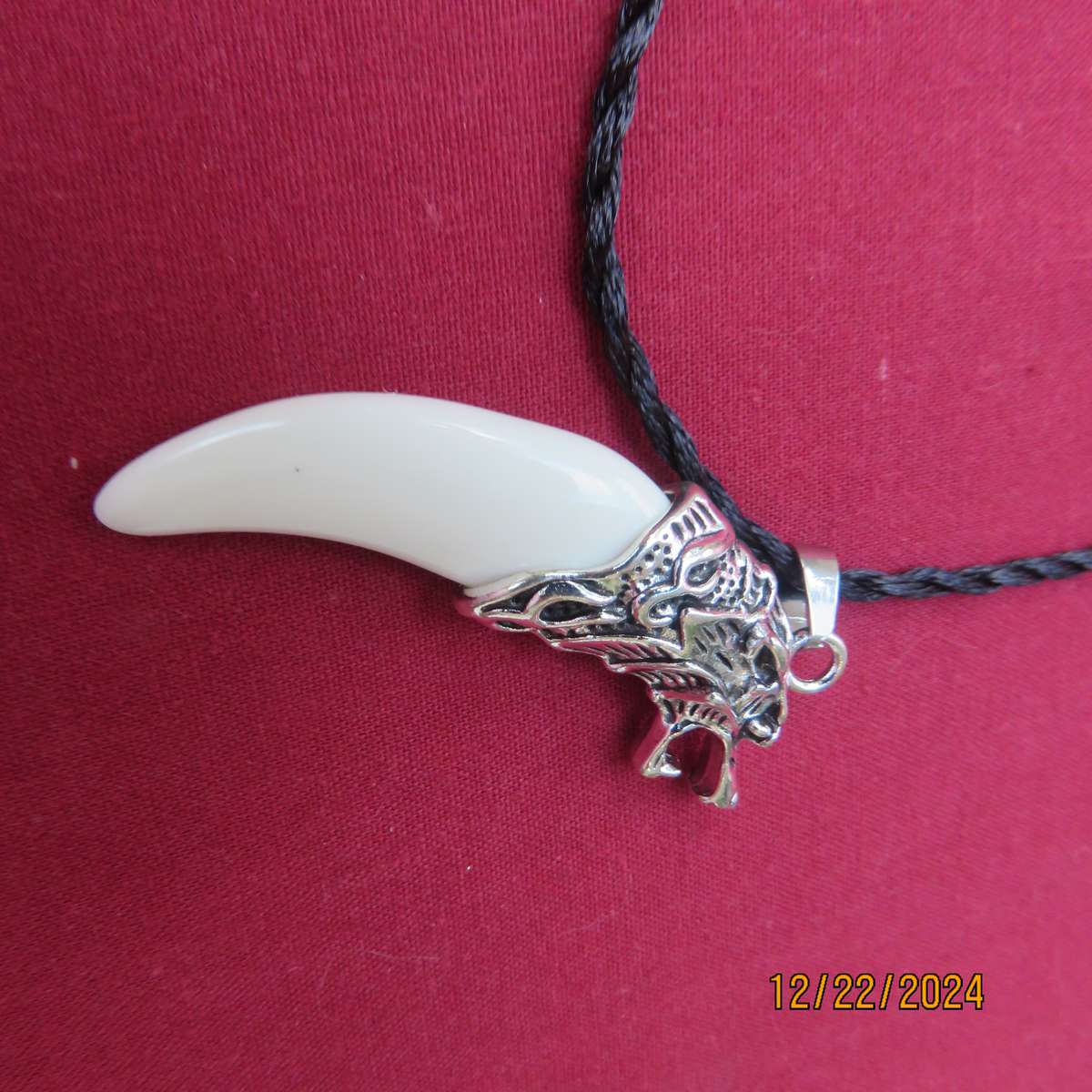 Faux tooth pendant in stainless steel with black cord