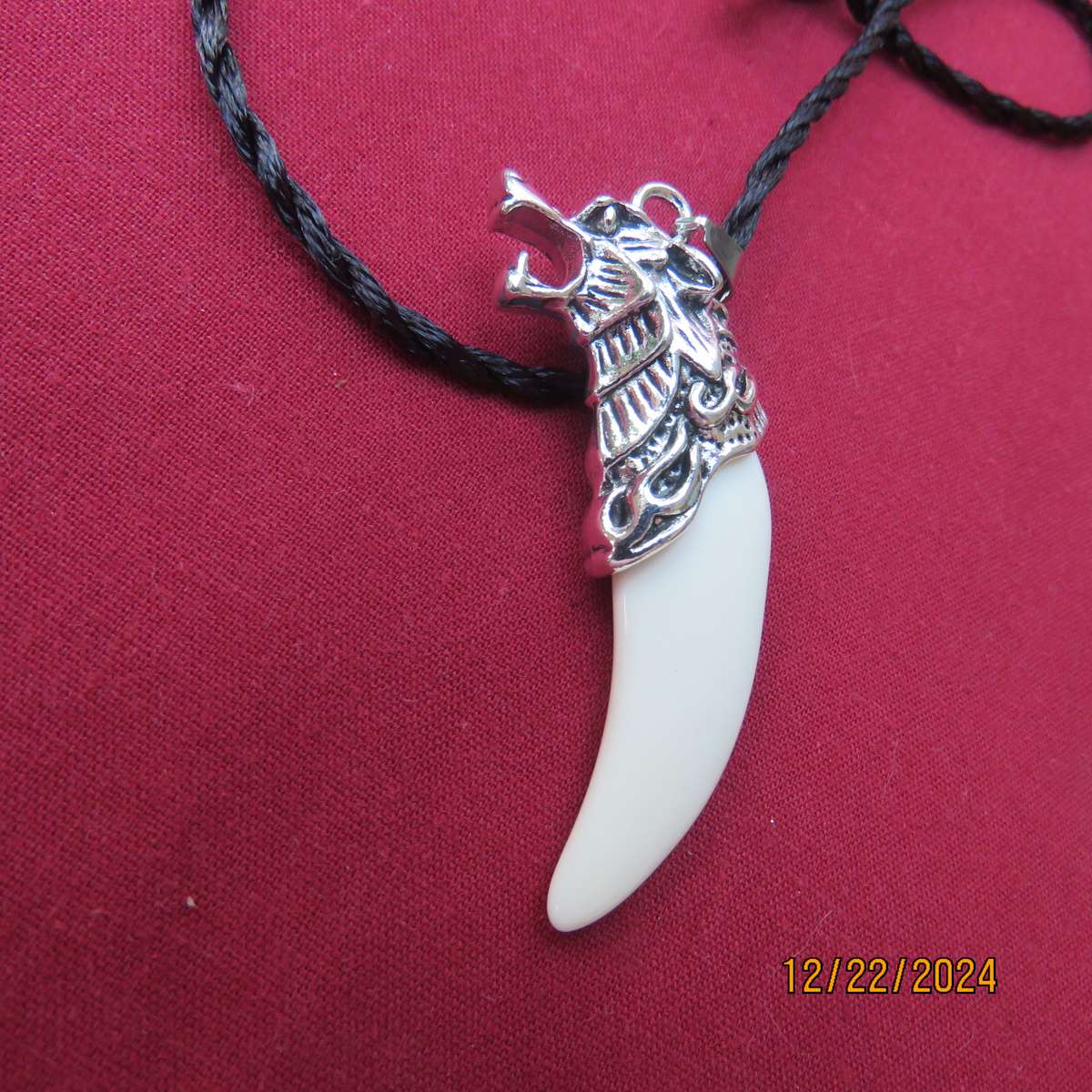 Faux tooth pendant in stainless steel with black cord