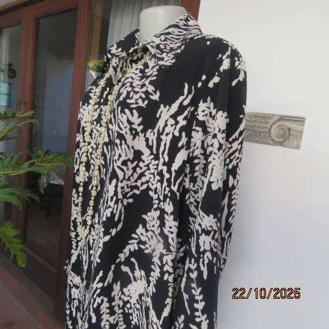 PENNY C black high quality polyester top with white floral print. Size 46-22