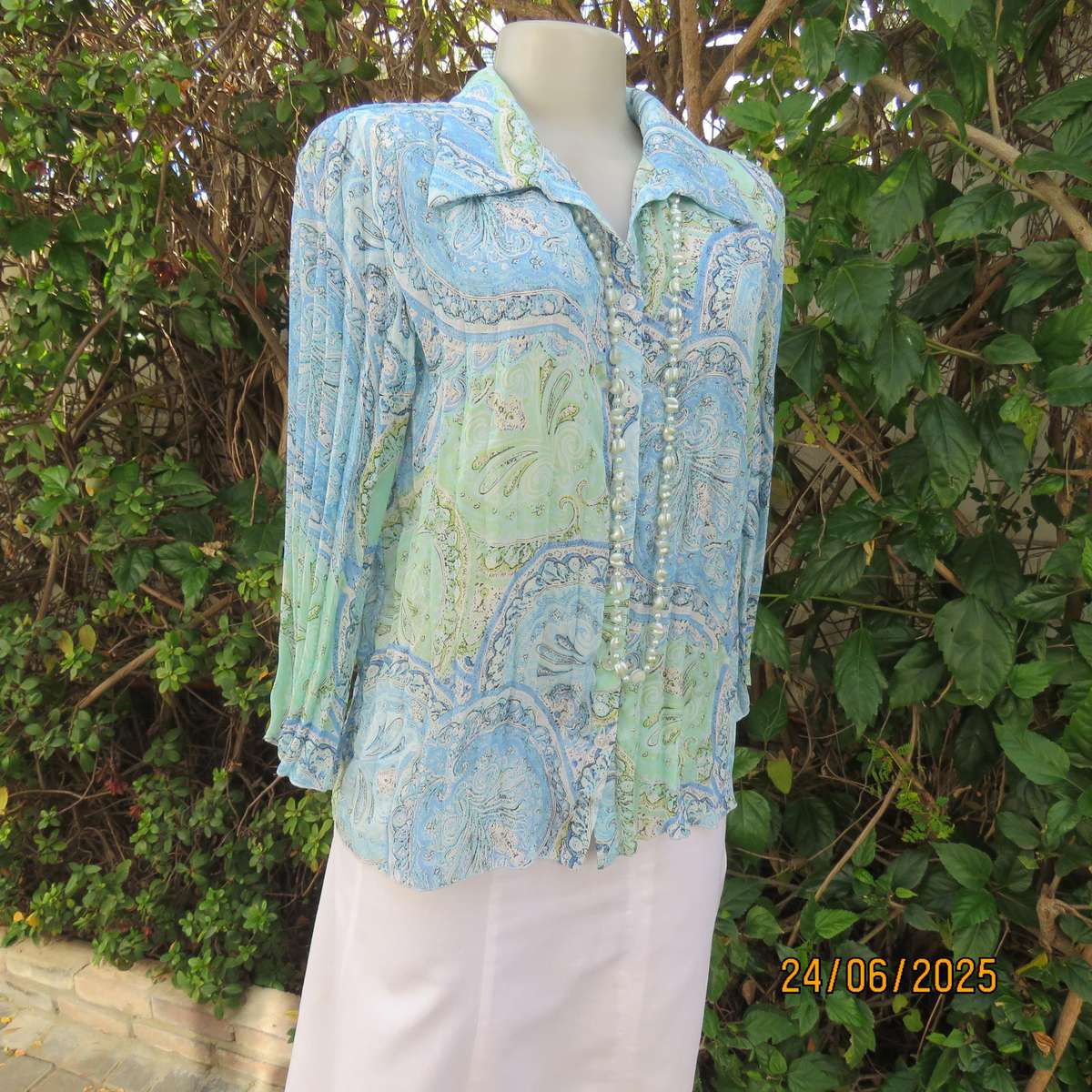 Soft blue-green permanent pleated paisley printed polyester top. Size 38.