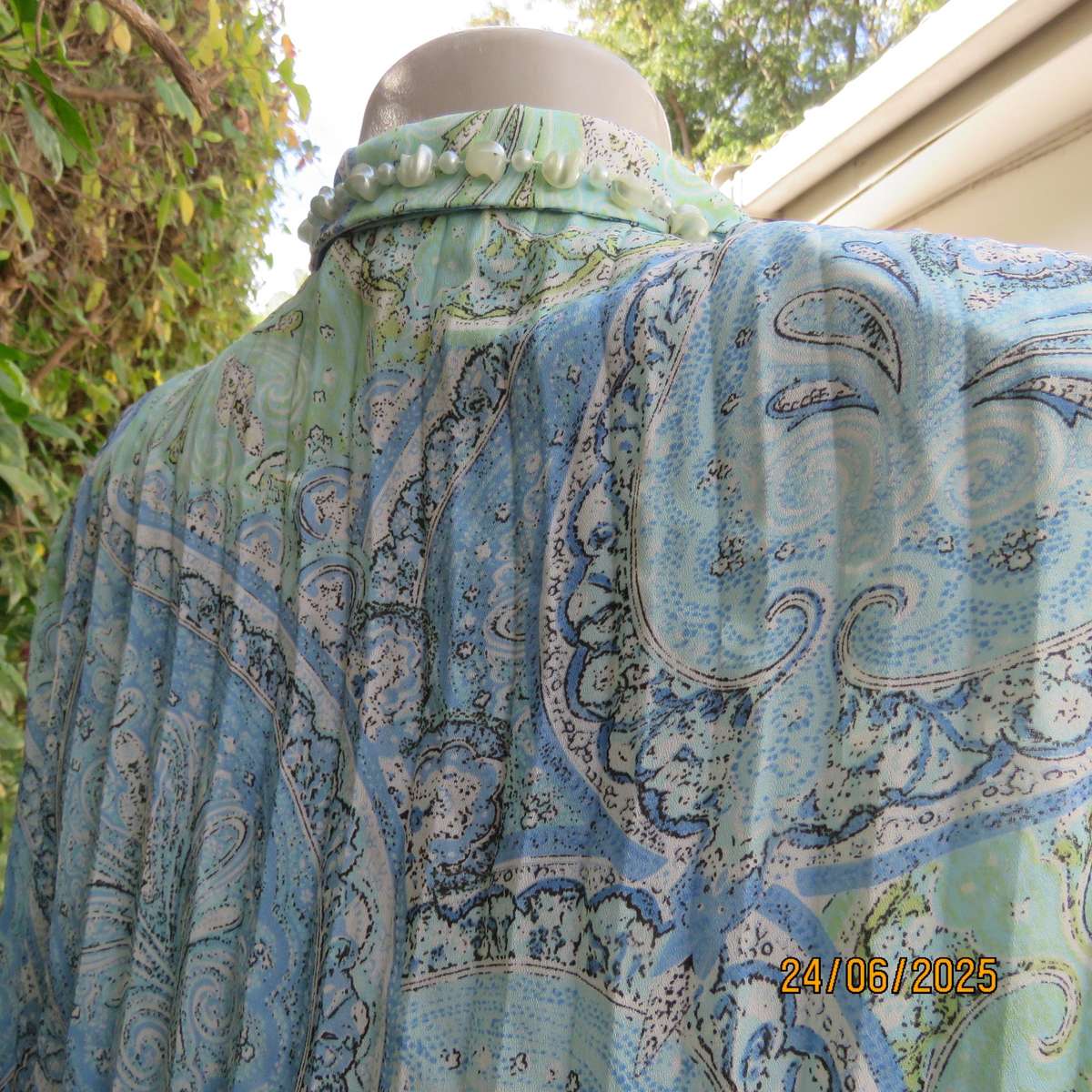 Soft blue-green permanent pleated paisley printed polyester top. Size 38.