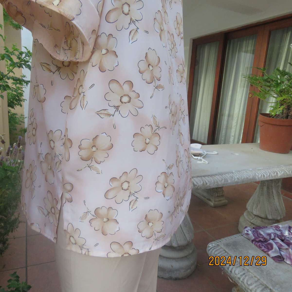 Tastefully printed flowers on pale peach background silky polyester short sleeve top.Size 40. As new