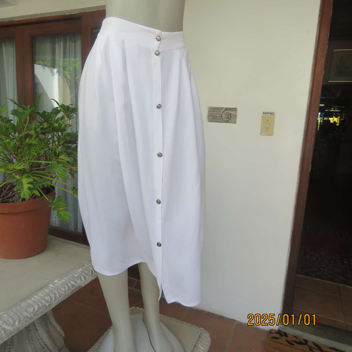 Cool white button down viscose calf length skirt. Knife pleats on front.Elasticated back. Size 36.
