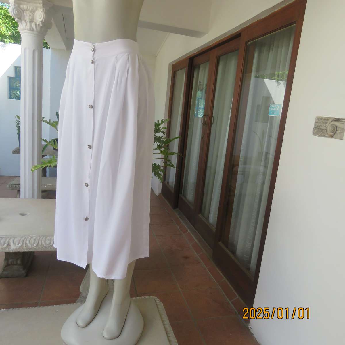 Cool white button down viscose calf length skirt. Knife pleats on front.Elasticated back. Size 36.